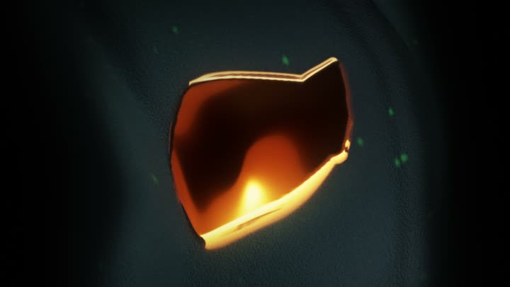 A gold form opening in the dark, lit from inside.