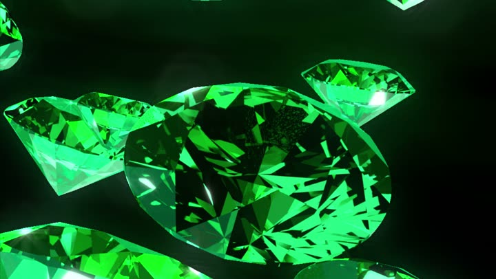 A macro of a single faceted emerald filling the frame.