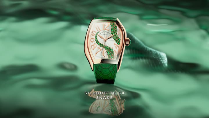 The Silhouette CX Snake watch standing on the green water, the snake behind it.