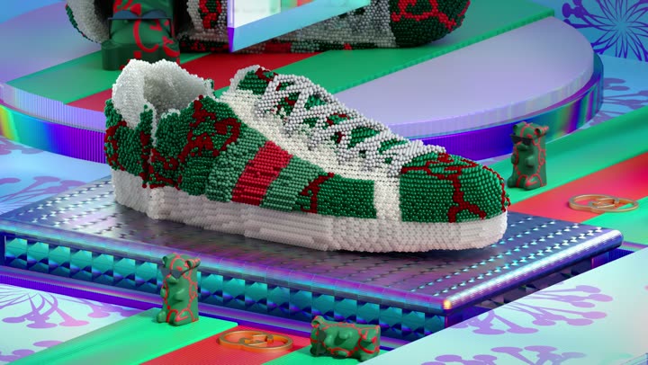The sneaker centred, the green and red web stripe visible in yarn.