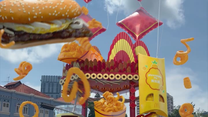 The burger above a Chinese New Year archway hung with gold decorations.